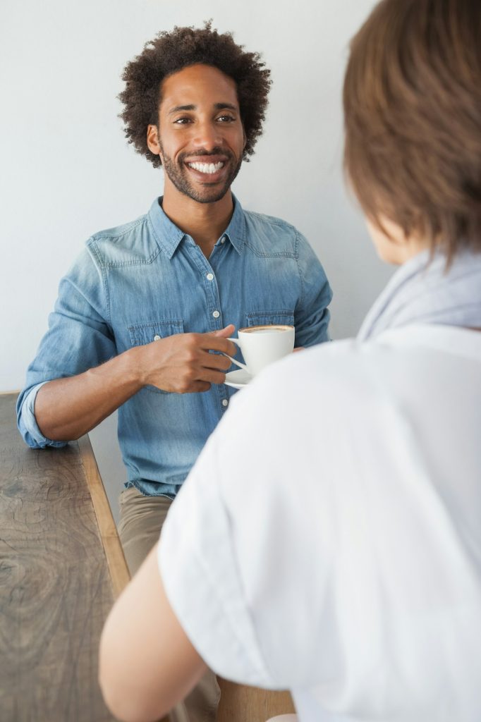 Casual man having a coffee with friend at the coffee shop
