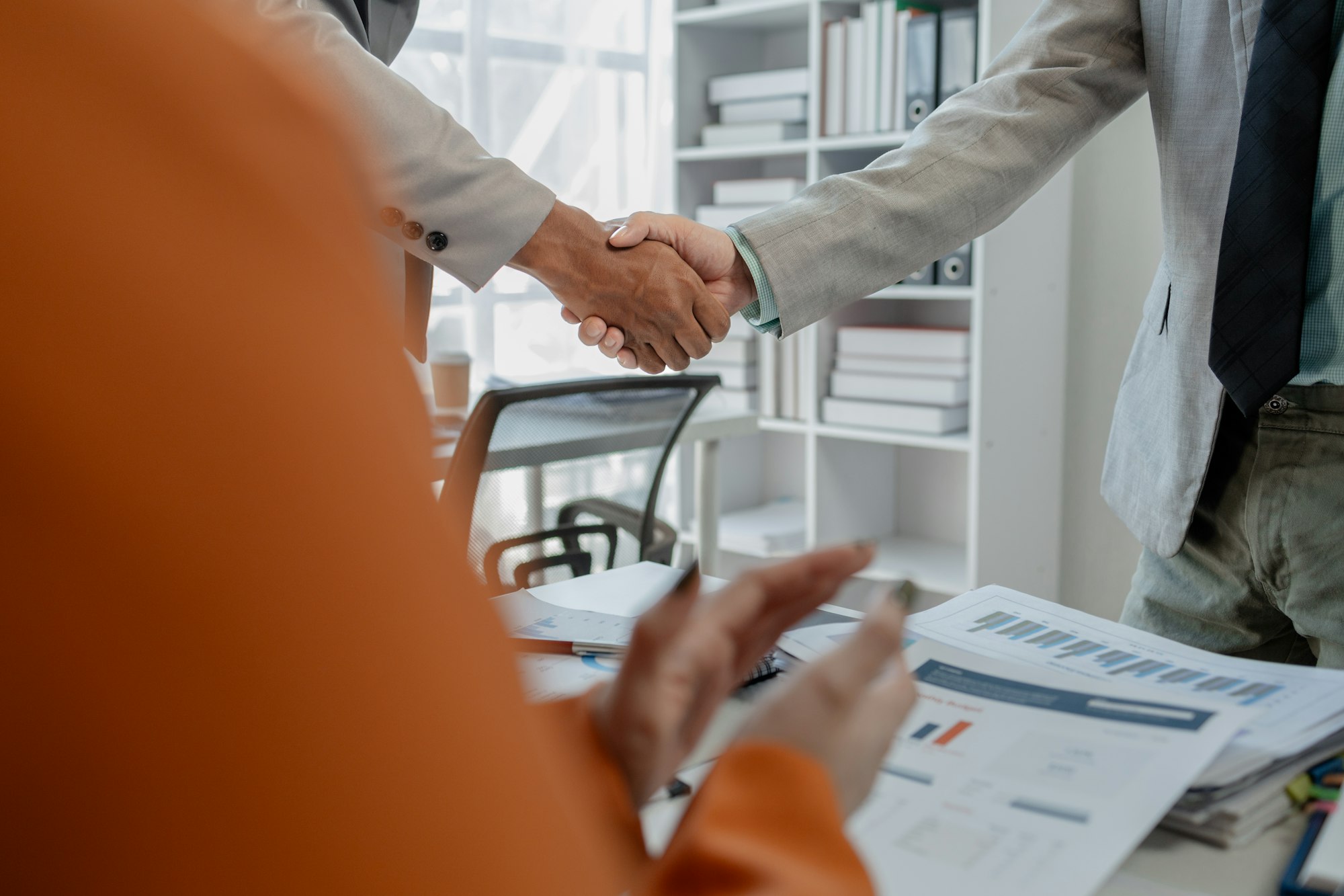 Meeting commitments in a meeting room at the office, Business people shaking hands in office, Shot o